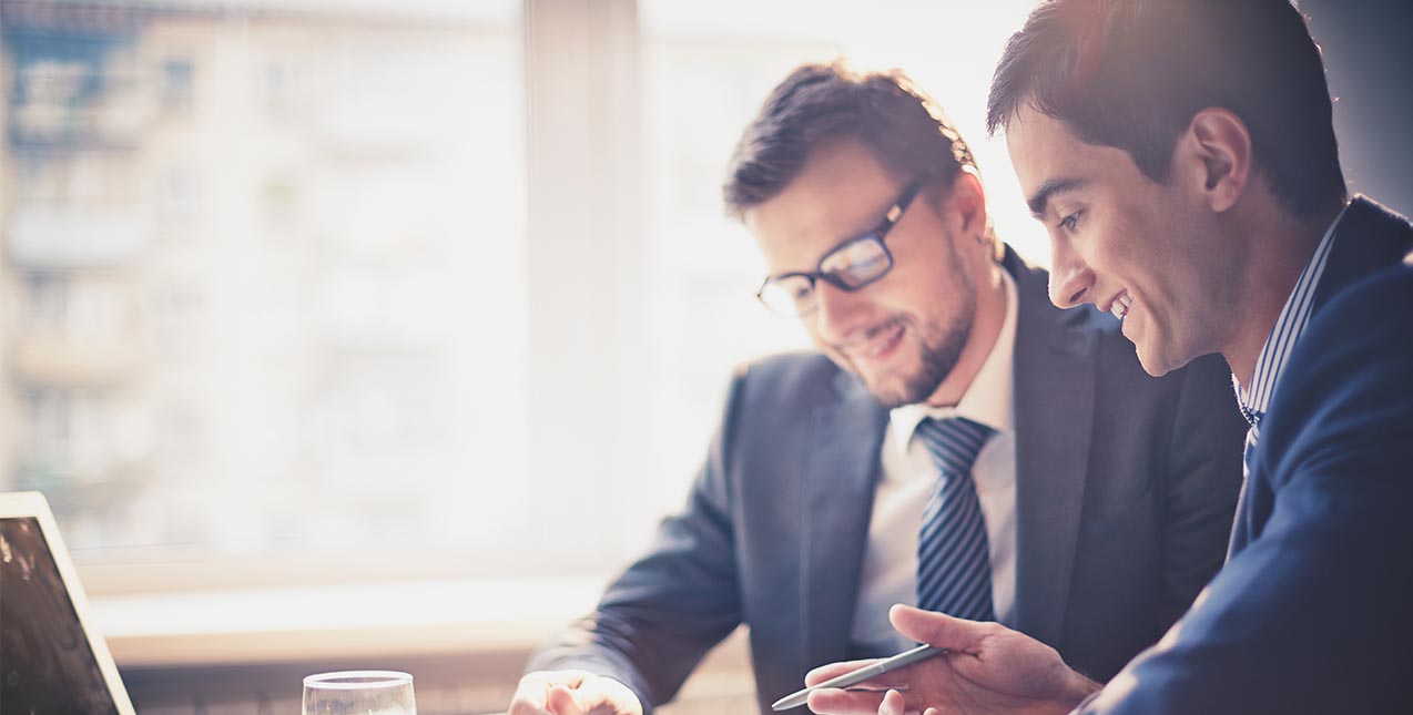 Two business men reviewing assets