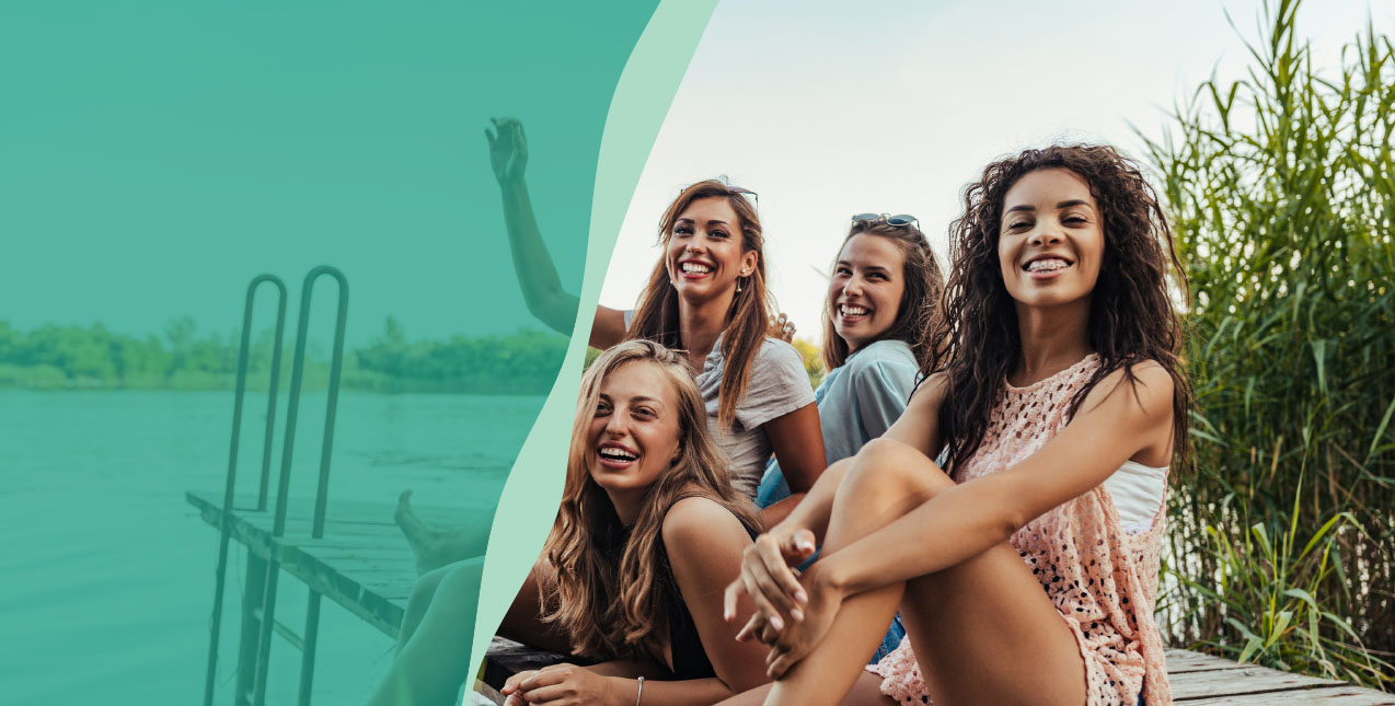 Friends hanging out on dock in summer