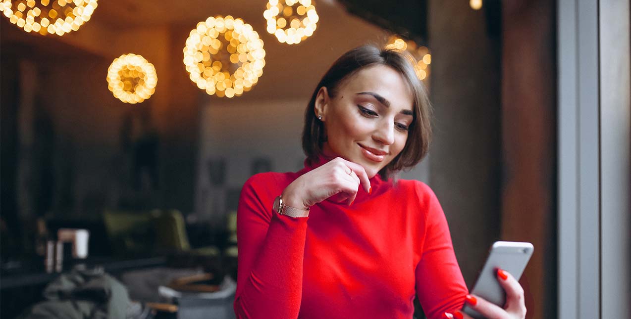 Bank Bold with Wheatland Bank - Girl in red sweater looking at mobile phone