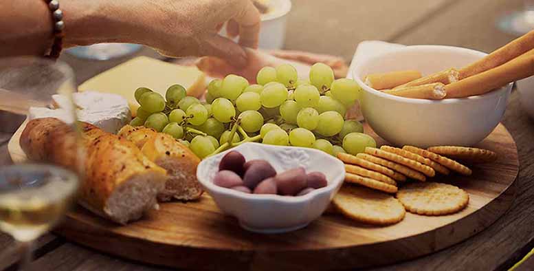 Gather around where the checking is free. 
Charcuterie board with snacks. 