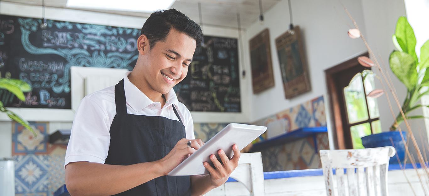 worker at shop on tablet